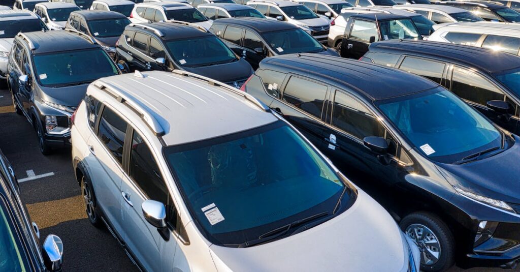 pexels-photo-5992514-5992514 Modern sparkling clean new automobiles on asphalt parking near factory of manufacture in daytime